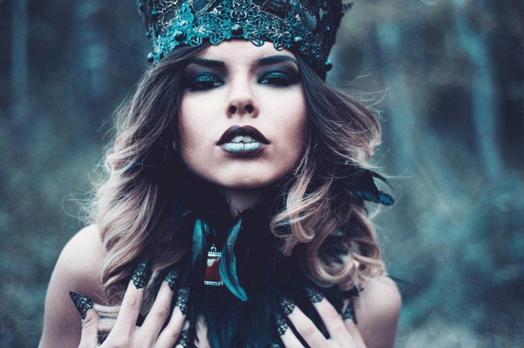 pexels-photo-2495692-2495692 Mystical portrait of a woman adorned in fantasy attire with dark makeup and a crown.